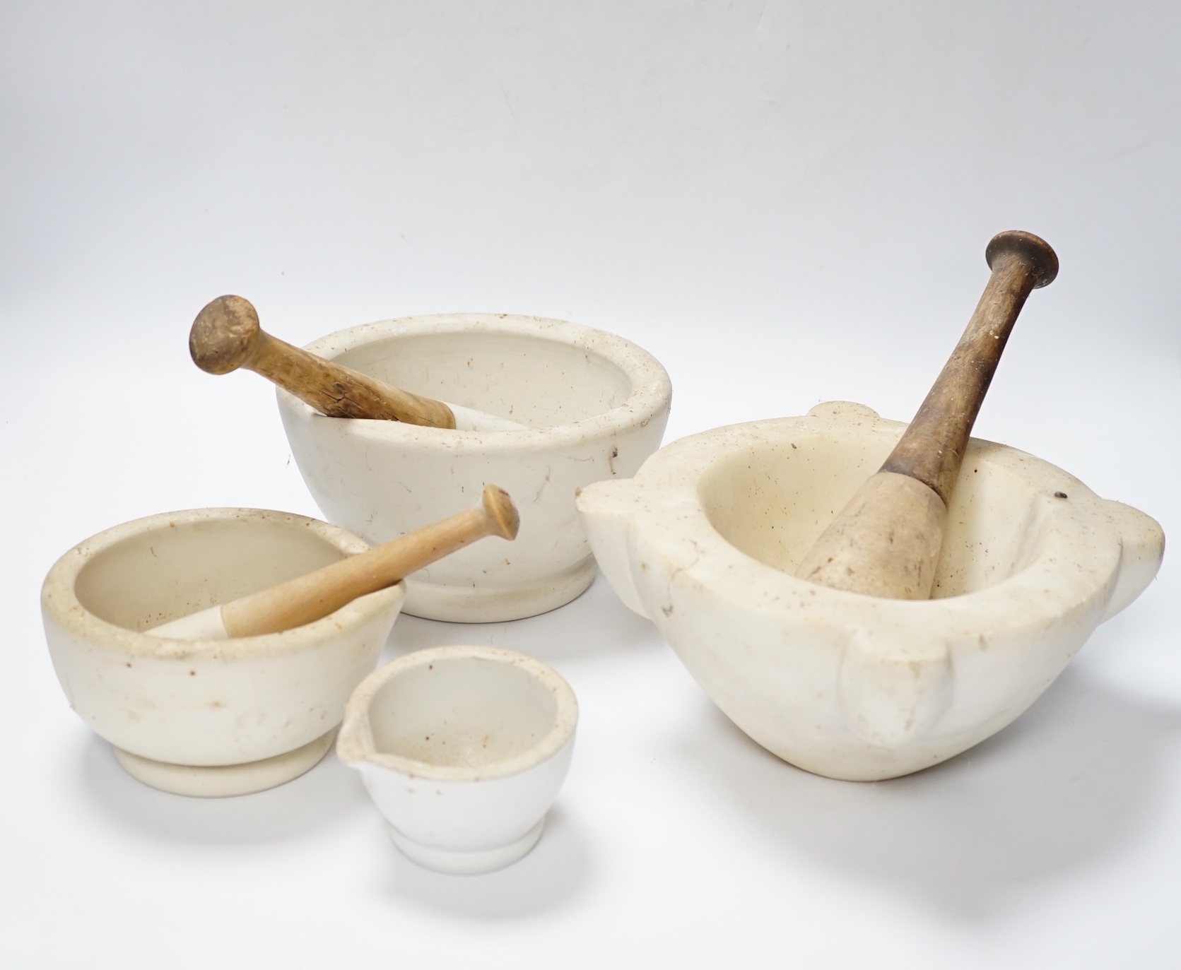 Four mortars and three pestles, largest 23cm wide